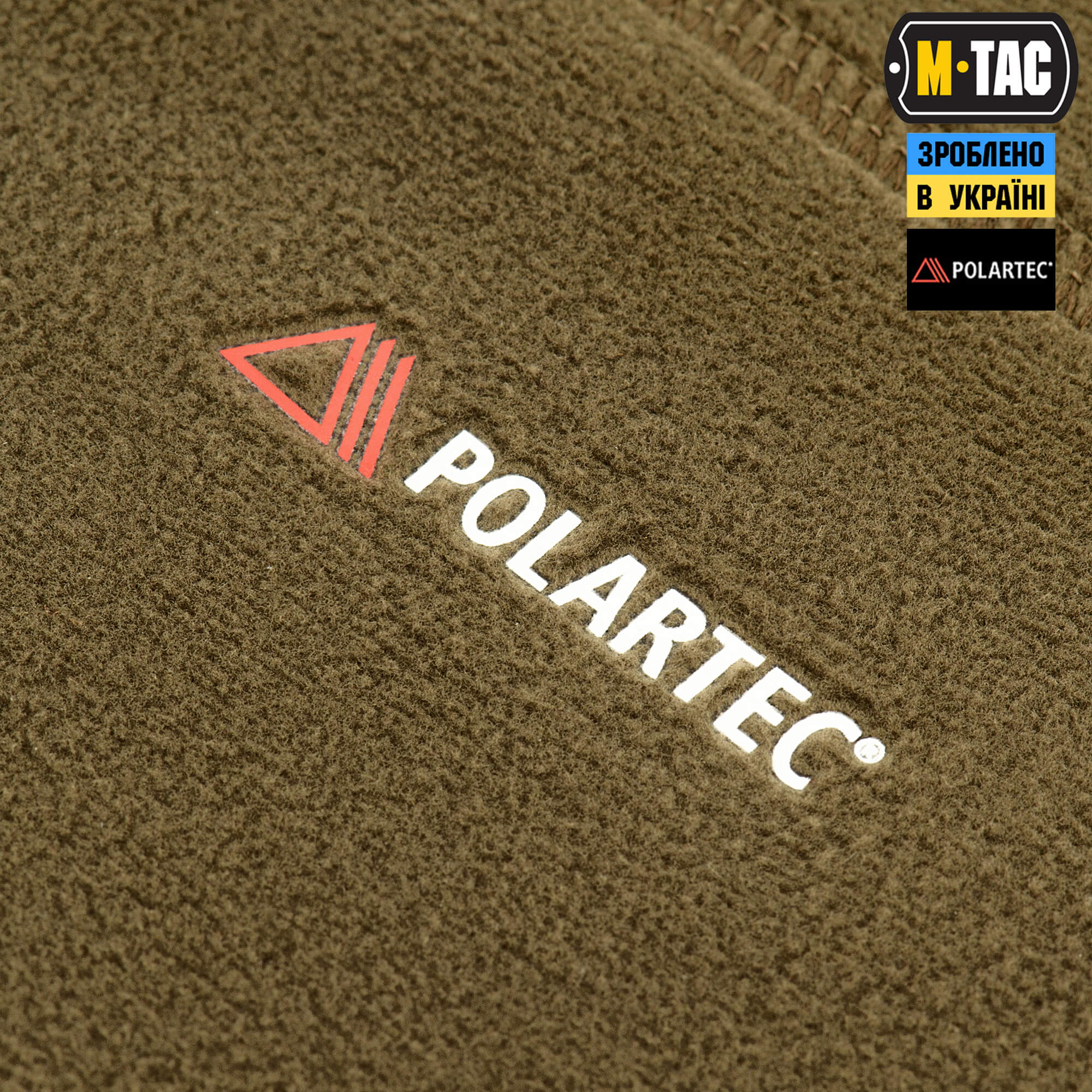 Close-up of Polartec logo on a textured surface with M-Tac branding above.
